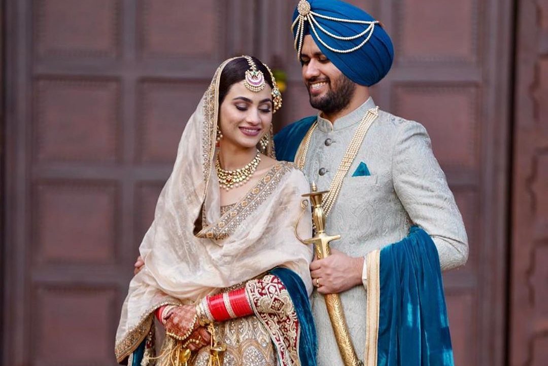 The Beautiful Bridal Lehenga compliments Groom's Punjabi Wedding attire at Jalandhar Venue